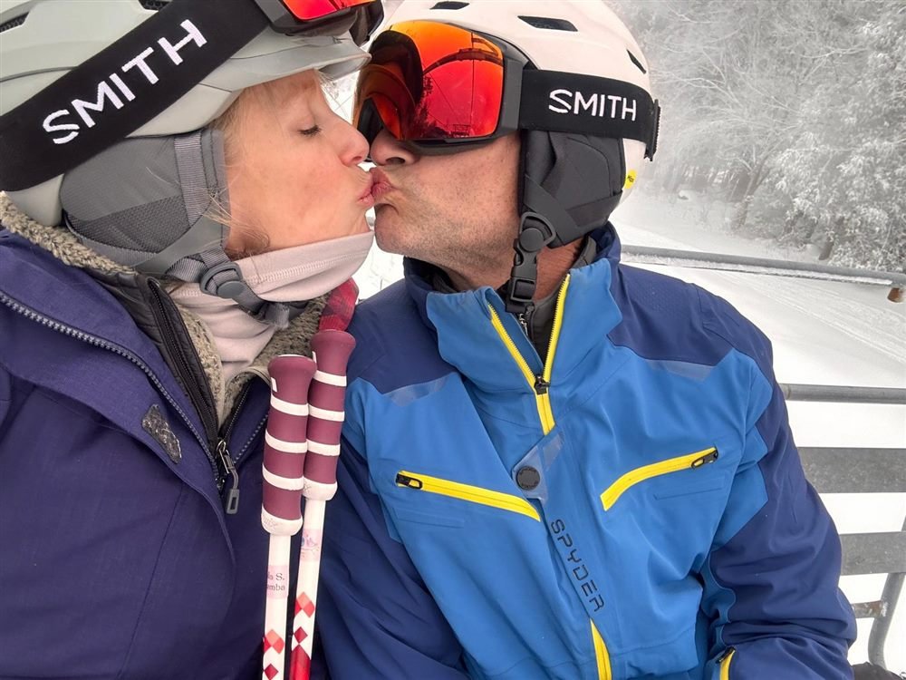 Bethany and Jeff kissing on a ski lift
