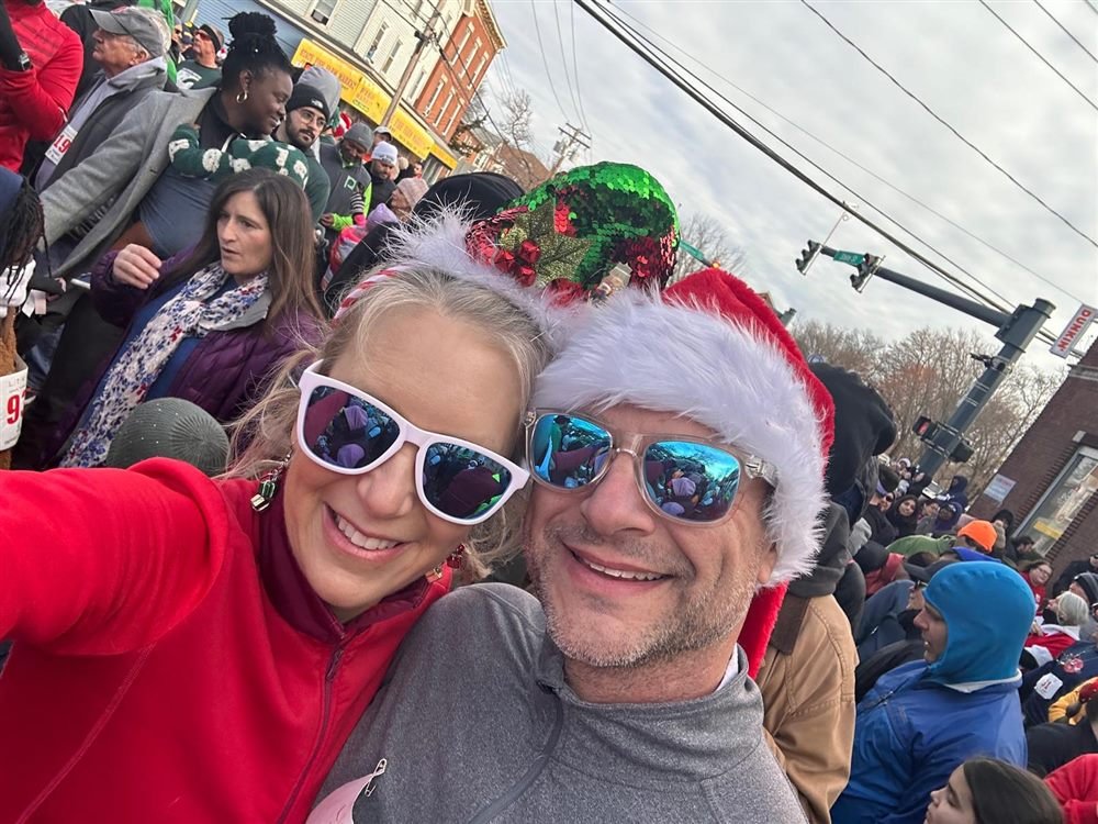 Bethany and Jeff in holiday hats and sunglasses